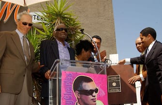 Clint Eastwood, Cicely Tyson, Joe Adams (center right) and Martin Ludlow (right) stand with Ray Charles (center) as he speaks at the unveiling of the plaque which dedicates The Ray Charles Studios as a historic landmark (Photo by Amy Graves/WireImage)