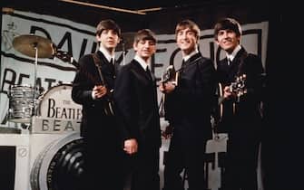 25th November 1963:  Liverpudlian beat combo The Beatles, from left to right Paul McCartney, Ringo Starr, John Lennon (1940 - 1980), and George Harrison (1943 - 2001), performing in front of a camera-shaped drum kit on Granada TV's Late Scene Extra television show filmed in Manchester, England on November 25, 1963.  (Photo by Hulton Archive/Getty Images)
