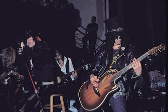 NEW YORK CITY, NY - JANUARY 31:  (L-R) Axl Rose, Izzy Stradlin and Slash of Guns N' Roses perform an acoustic set at The Limelight on January 31, 1988 in New York City. ( Photo By Larry Marano/Getty Images)