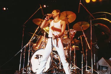 Freddie Mercury (1946-1991), singer with Queen, standing in front of a drumkit as he sings into a microphone on stage during a live concert performance by the band at the National Bowl in Milton Keynes, England, United Kingdom,  on 5 June 1982. (Photo by Fox Photos/Hulton Archive/Getty Images)
