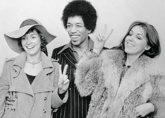 Rock star Jimi Hendrix is acquitted of drug possession charges. His female friends give the peace sign.
