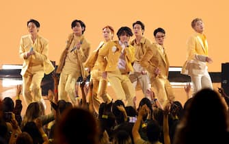 LOS ANGELES, CALIFORNIA - NOVEMBER 21: (L-R) J-Hope, V, Suga, Jimin, Jin, Jungkook, and RM of BTS perform onstage during the 2021 American Music Awards at Microsoft Theater on November 21, 2021 in Los Angeles, California. (Photo by Kevin Winter/Getty Images for MRC)