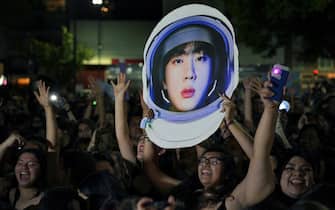 Fans of South Korean K-Pop boy band unable to attend the show, gather outside the River Plate's Monumental stadium to listen to Kim Seok-jin -aka Jin- perform his single solo "The Astronaut" with British rock band Coldplay, during the third of ten concerts of their "Music of the Spheres" world tour, in Buenos Aires, on October 28, 2022. (Photo by JUAN MABROMATA / AFP) (Photo by JUAN MABROMATA/AFP via Getty Images)