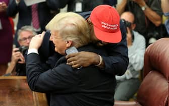 WASHINGTON, DC - OCTOBER 11:  (AFP OUT) U.S. President Donald Trump hugs rapper Kanye West during a meeting in the Oval office of the White House on October 11, 2018 in Washington, DC. (Photo by Oliver Contreras - Pool/Getty Images)