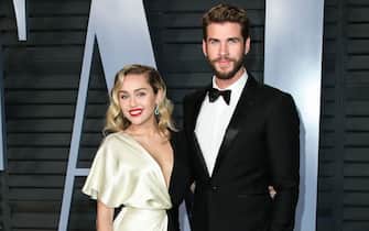(FILE) Miley Cyrus and Liam Hemsworth Appear to Be Married.  Miley Cyrus and Liam Hemsworth appeared to have tied the knot six years after getting engaged.  Miley Cyrus and Liam Hemsworth are believed to have tied the knot in a low-key ceremony at home.  The singer, 26, and actor, 28, who got engaged six years ago, have been seen cutting their wedding cake in a series of photos on social media.  BEVERLY HILLS, LOS ANGELES, CA, USA - MARCH 04: Singer Miley Cyrus and boyfriend/actor Liam Hemsworth arrive at the 2018 Vanity Fair Oscar Party held at the Wallis Annenberg Center for the Performing Arts on March 4, 2018 in Beverly Hills, Los Angeles, California, United States.