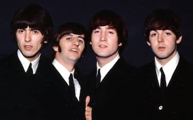 1964: Rock and roll band 'The Beatles' pose for a portrait wearing suits in 1964. (L-R) George Harrison, Ringo Starr, John Lennon, Paul McCartney. (Photo by Michael Ochs Archives/Getty Images)