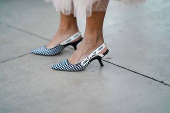 PARIS, FRANCE - NOVEMBER 27: Ellie Delphine wears black and white houndstooth pattern printed pointy Dior J'Adior shoes, on November 27, 2020 in Paris, France. (Photo by Edward Berthelot/Getty Images)