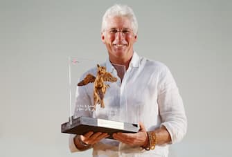 GIFFONI VALLE PIANA, ITALY - JULY 22:  Actor Richard Gere poses with the Truffaut Award during the Giffoni Film Festival photocall on July 22, 2014 in Giffoni Valle Piana, Italy.  (Photo by Vittorio Zunino Celotto/Getty Images for Giffoni Film Festival)