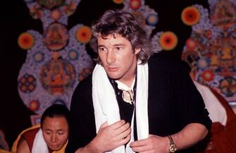 View of American actor and chairman of the Tibet House Richard Gere, with Indian monks from the Tantric Monastery of Gyuto, during a demonstration of butter sculptures held at the American Museum of Natural History, New York, New York, February 24, 1989. (Photo by Rita Barros/Getty Images)