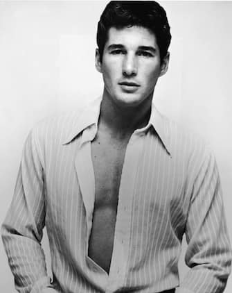 Studio portrait of American actor Richard Gere wearing an open shirt, late 1970s. (Photo by American Stock/Getty Images) 