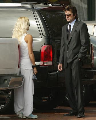 MALIBU, CA - APRIL 10: Pamela Anderson talks with former husband and musician Tommy Lee, drummer for Motley Crue, at the Malibu Courthouse after a probation progress report April 10, 2003 in Malibu, California. The progress report stems from a plea of no contest to an alleged physical altercation with his then wife, Pamela Anderson Lee in 1998.  (Photo by Frazer Harrison/Getty Images) 