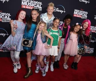 BURBANK, CALIFORNIA - JULY 27: Jojo Siwa (C) poses with the musical group XOMG POP! at Disney+ "High School Musical: The Musical: The Series" Season 3 premiere at Walt Disney Studios on July 27, 2022 in Burbank, California. (Photo by David Livingston/FilmMagic)