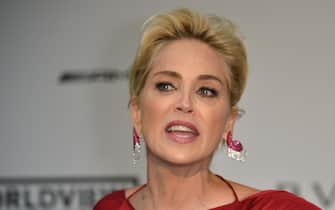 US actress Sharon Stone speaks to the photographers as she arrives on May 22, 2014 for the amfAR 21st Annual Cinema Against AIDS during the 67th Cannes Film Festival at Hotel du Cap-Eden-Roc in Cap d'Antibes, southern France.  AFP PHOTO / ALBERTO PIZZOLI