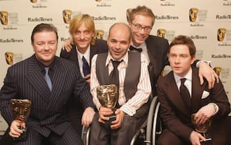 LONDON - APRIL 18:   Actor Ricky Gervais (L) poses with the fellow members of The Office the pressroom with awards for Best Situation Comedy and Comedy performance following the "The British Academy Television Awards" at the Grosvenor House Hotel on April 18, 2004 in London. (Photo by Steve Finn/Getty Images) 
 *** Local Caption *** Ricky Gervais