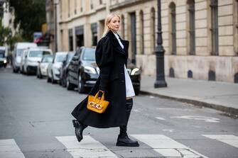 PARIS, FRANCE - OCTOBER 08: Leonie Hanne is seen wearing white J.W. Anderson blouse dress, J.W. Anderson bag,  J.W. Anderson, black Bottega Veneta boots during a Street Style Fashion Photo Session on October 08, 2020 in Paris, France. (Photo by Christian Vierig/Getty Images)