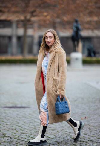 BERLIN, GERMANY - DECEMBER 01: Sonia Lyson is seen wearing creme white two tone Bottega Veneta Tire boots, Ducie London hoody and jogger pants with print, beige teddy coat Sandro, blue Dior bag on December 01, 2020 in Berlin, Germany. (Photo by Christian Vierig/Getty Images)
