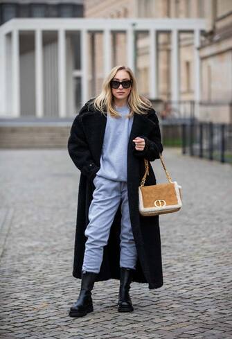 BERLIN, GERMANY - DECEMBER 01: Sonia Lyson is seen wearing black Ducie boots, Dior bag in beige, black teddy coat and grey jogger pants and top Sundarbay, Jimmy Choo sunglasses on December 01, 2020 in Berlin, Germany. (Photo by Christian Vierig/Getty Images)