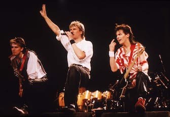 Bassist John Taylor (L), singer Simon Le Bon, and guitarist Andy Taylor of the British pop group Duran Duran performing on stage during a concert, 1984. (Photo by Hulton Archive/Getty Images)  