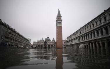 A general view shows flooded St. Mark's square, St. Mark's Basilica and the Bell Tower after an exceptional overnight "Alta Acqua" high tide water level, early on November 13, 2019 in Venice. - Powerful rainstorms hit Italy on November 12, with the worst affected areas in the south and Venice, where there was widespread flooding. Within a cyclone that threatens the country, exceptional high water were rising in Venice, with the sirocco winds blowing northwards from the Adriatic sea against the lagoons outlets and preventing the water from flowing back into the sea. At 22:40pm the tide reached 183 cm, the second measure in history after the 198 cm of the 1966 flood. (Photo by Marco Bertorello / AFP) (Photo by MARCO BERTORELLO/AFP via Getty Images)