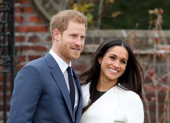 880232960 LONDON, ENGLAND - NOVEMBER 27: Prince Harry and actress Meghan Markle during an official photocall to announce their engagement at The Sunken Gardens at Kensington Palace on November 27, 2017 in London, England. Prince Harry and Meghan Markle have been a couple officially since November 2016 and are due to marry in Spring 2018. (Photo by Chris Jackson/Chris Jackson/Getty Images)