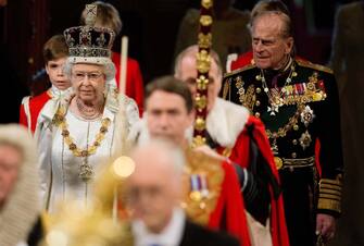 LONDON, ENGLAND - MAY 09: Queen Elizabeth II, wearing the Imperial State Crown, and Prince Philip, Duke of Edinburgh proceed through the Royal Gallery in the Palace of Westminster during the State Opening of Parliament on May 9, 2012 in London, England. Queen Elizabeth II unveiled the coalition government's legislative programme in a speech delivered to Members of Parliament and Peers in The House of Lords. New legislation is expected to be introduced on banking reform, House of Lords reform, changes to public sector pensions and plans for increased internet monitoring.  (Photo by Leon Neal - WPA Pool/Getty Images)
