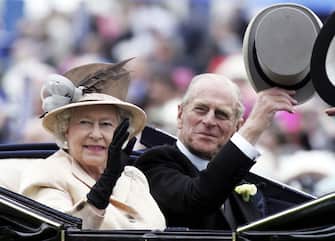 YORK, ENGLAND - JUNE 16:  HM Queen Elizabeth II , The Queen, and husband Prince Philip, the Duke of Edinburgh, arrive in the Royal Carriage on the third day of Royal Ascot 2005, Ladies' Day, at York Racecourse on June 16, 2005 in York, England. One of the highlights of the racing and social calendars, Royal Ascot was founded in 1711 by Queen Anne and royal patronage continues to the present day with a Royal Procession taking place in front of the grandstands each day. This year's Royal Meeting is relocated to York Racecourse due to a major redevelopment programme at Ascot, due to re-open in 2006.  (Photo by Chris Jackson/Getty Images)