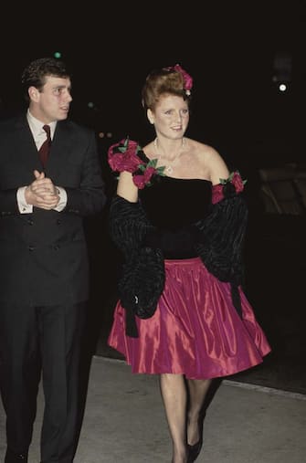 British Royals Prince Andrew, Duke of York and Sarah, Duchess of York, wearing a pink-and-black Lindka Cierach dress with floral decoration on the shoulder, attend a fashion show at The Music Centre in Los Angeles, California, 1st March 1988. The Duke and Duchess are on an official tour of the United States. (Photo by Tim Graham Photo Library via Getty Images)