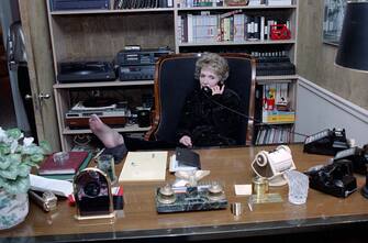 12-24-1986 Nancy Reagan talking on telephone and with bare feet on desk at a Christmas Eve Party at the Wick Residence in Washington, DC