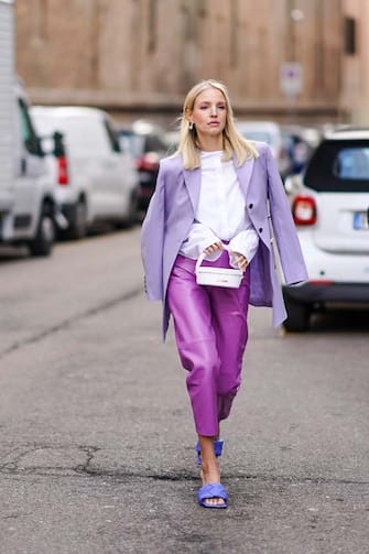 MILAN, ITALY - FEBRUARY 20: Leonie Hanne wears a mauve oversized blazer jacket, a white shirt, a white bag from Jacquemus, purple leather cropped pants, blue quilted sandals, outside Max Mara, during Milan Fashion Week Fall/Winter 2020-2021 on February 20, 2020 in Milan, Italy.  (Photo by Edward Berthelot/Getty Images)
