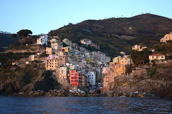 509604780 RIOMAGGIORE, ITALY - NOVEMBER 1, 2015: The colorful seaside town of Riomaggiore on Italy's northwest coast is one of five villages which comprise the Cinque Terre region popular with tourists. The string of centuries-old villages on the rugged Italian Riviera coastline, and the surrounding hillsides, are all part of the Cinque Terre National Park and is a UNESCO World Heritage site. (Photo by Robert Alexander/Getty Images)