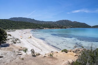 1226613260 PORTO CERVO, ITALY - MAY 23: A small amount of people take to the beach on May 23, 2020 in Porto Cervo, Sardinia, Italy. After more than two months of Lockdown due to Covid-19, Governor Christian Solinas has now allowed people to go to the beach again. Restaurants, bars, cafes, hairdressers and other shops have reopened, subject to social distancing measures, after more than two months of a nationwide lockdown meant to curb the spread of Covid-19. (Photo by Emanuele Perrone/Getty Images)