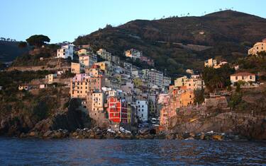 RIOMAGGIORE, ITALY - NOVEMBER 1, 2015: The colorful seaside town of Riomaggiore on Italy's northwest coast is one of five villages which comprise the Cinque Terre region popular with tourists. The string of centuries-old villages on the rugged Italian Riviera coastline, and the surrounding hillsides, are all part of the Cinque Terre National Park and is a UNESCO World Heritage site. (Photo by Robert Alexander/Getty Images)