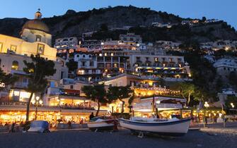 120254533 POSITANO, ITALY - JULY 27: The town center stands illuminated at dusk on July 27, 2011 in Positano, Italy. The Amalfi coastline is among Italy's most popular tourist destinations. (Photo by Sean Gallup/Getty Images)