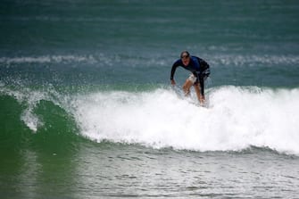 1231314950 This picture taken on January 23, 2021 shows Bruce Lucas, an Australian shark attack survivor, surfing on Crowdy Bay National Park at Port Macquarie, some 127 kilometres (79 miles) northeast of Sydney. - Bruce Lucas was bitten while he fought off a bull shark at Saltwater beach on the mid north coast of New South Wales in 2015. (Photo by Wendell Teodoro / AFP) / TO GO WITH Australia-animal-shark,FOCUS (Photo by WENDELL TEODORO/AFP via Getty Images)