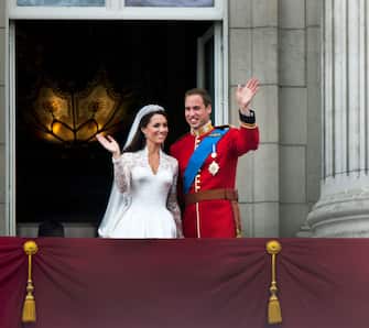 113810580 Prince William and Catherine, Duchess of Cambridge greet well-wishers from the balcony at Buckingham Palace after their wedding, London, 29th April 2011. (Photo by Tom Stoddart/Getty Images)