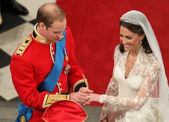 113266946 LONDON, ENGLAND - APRIL 29: Prince William exchanges rings with his bride Catherine Middleton in front of the Archbishop of Canterbury, Rowan Williams inside Westminster Abbey on April 29, 2011 in London, England. The marriage of Prince William, the second in line to the British throne, to Catherine Middleton is being held in London today. The marriage of the second in line to the British throne is to be led by the Archbishop of Canterbury and will be attended by 1900 guests, including foreign Royal family members and heads of state. Thousands of well-wishers from around the world have also flocked to London to witness the spectacle and pageantry of the Royal Wedding. (Photo by Andrew Milligan - WPA Pool/Getty Images)