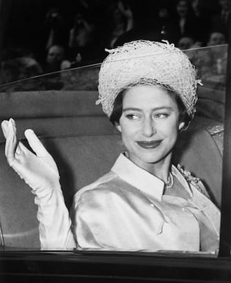 515488768 (Original Caption) Princess Margaret waves from her coach at Buckingham Palace here May 6th as she leaves on her honeymoon with Antony Armstrong-Jones.