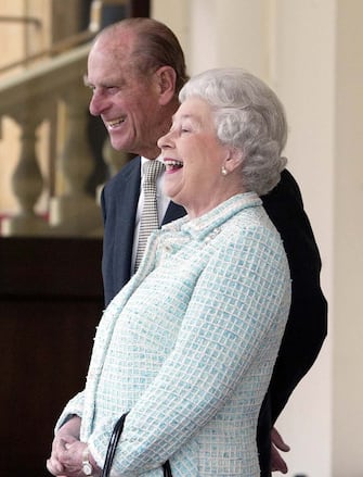 BRITAIN POLAND Britain's Queen Elizabeth II and Prince Phillip laugh, as President Alexandre Kwasniewski of Poland and his wife Jolanta Kwasniewska left Buckingham Palace in London, Friday May 7, 2004, after an official two day State Visit to the United Kingdom(AP Photo/Dave Caulkin, pool)