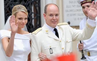117962627 MONACO - JULY 02: Princess Charlene of Monaco and Prince Albert II of Monaco wave to the crowd as they leave Sainte Devote church after their religious wedding ceremony at the Prince's Palace of Monaco on July 2, 2011 in Monaco. The Roman-Catholic ceremony followed the civil wedding which was held in the Throne Room of the Prince's Palace of Monaco on July 1. With her marriage to the head of state of the Principality of Monaco, Charlene Wittstock has become Princess consort of Monaco and gains the title, Princess Charlene of Monaco. Celebrations including concerts and firework displays are being held across several days, attended by a guest list of global celebrities and heads of state. (Photo by Gareth Cattermole/Getty Images)