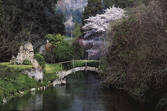 Bridge over Ninfa river, Gardens of Ninfa, WWF Oasis, Cisterna di Latina, Lazio, Italy.
