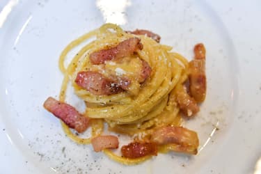 A view of the traditional famous Italian pasta dish "spaghetti alla carbonara", is taken during a preview for the press on April 5, 2019, one day before the international event Carbonara Day (#CarbonaraDay) in Rome. - The preview consists of three teams of cooking students challenge each other with modified Carbonara dishes, a traditional one, a vegan one and an experimental one. (Photo by Andreas SOLARO / AFP) (Photo credit should read ANDREAS SOLARO/AFP via Getty Images)