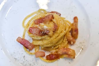 1135203306 A view of the traditional famous Italian pasta dish "spaghetti alla carbonara", is taken during a preview for the press on April 5, 2019, one day before the international event Carbonara Day (#CarbonaraDay) in Rome. - The preview consists of three teams of cooking students challenge each other with modified Carbonara dishes, a traditional one, a vegan one and an experimental one. (Photo by Andreas SOLARO / AFP) (Photo credit should read ANDREAS SOLARO/AFP via Getty Images)