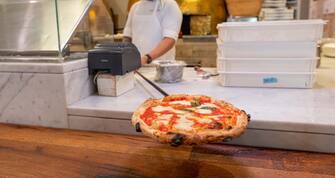 1313757148 NEW YORK, NEW YORK - APRIL 21: A cook makes a Neapolitan pizza as Eataly NYC Downtown reopens with Color Factory for La Pizza & La Pasta A Colori art installation created by artist Eric Rieger (AKA HOTTEA) on April 21, 2021 in New York City. Eataly will donate 10% of the proceeds to EnChroma’s Color Accessibility Program to help provide EnChroma glasses to local New York libraries for color blind patrons to borrow. (Photo by Noam Galai/Getty Images)