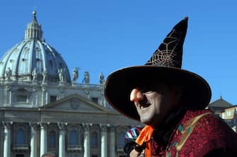 461078312 VATICAN CITY, VATICAN - JANUARY 06: A person dressed as Befana waits in St Peter's Square during the Feast of the Epiphany for Pope Francis' Angelus blessing on January 6, 2015 in Vatican City, Vatican. In Italian folk law, an old woman called Befena delivers presents to children in Italy on the eve of the Epiphany. During his homily at the Epiphany mass today, the Pope Francis focused on the journey taken by the three wise men, which is celebrated today, and encouraged Catholics to keep a strong faith. (Photo by Franco Origlia/Getty Images)
