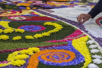 966599782 SPELLO, ITALY - JUNE 03: People decorate the streets with flower petals during the Infiorata festival ahead of the religious procession of Corpus Domini on June 3, 2018 in Spello, Italy. The 'INFIORATA' event has became a true tribute to the Corpus Domini religious feast, which takes place on the ninth Sunday after Easter. Dating back to the seventeenth century, floral creations cover streets throughout the town of Spello in preparation to the passage of the Blessed Sacrament carried in procession by the bishop on Sunday morning. (Photo by Tony Anna Mingardi/Awakening/Getty Images)