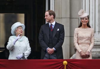 Britain's Queen Elizabeth II, left, looks on as Prince William, and Kate, Duchess of Cambridge appear on the balcony of Buckingham Palace in central London, Tuesday, June 5, 2012, to conclude the four-day Diamond Jubilee celebrations to mark the 60th anniversary of the Queen's accession to the throne. (AP Photo/Lefteris Pitarakis)
