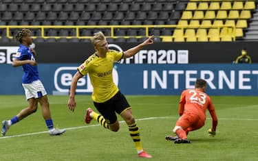 Dortmund's Norwegian forward Erling Braut Haaland celebrates after scoring the opening goal during the German first division Bundesliga football match BVB Borussia Dortmund v Schalke 04 on May 16, 2020 in Dortmund, western Germany as the season resumed following a two-month absence due to the novel coronavirus COVID-19 pandemic. (Photo by Martin Meissner / POOL / AFP) / DFL REGULATIONS PROHIBIT ANY USE OF PHOTOGRAPHS AS IMAGE SEQUENCES AND/OR QUASI-VIDEO (Photo by MARTIN MEISSNER/POOL/AFP via Getty Images)