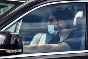 Juventus' Uruguayan midfielder Rodrigo Bentancur, wearing a face mask, arrives in his car to attend a training session on May 18, 2020 at the Continassa training ground in Turin during the country's lockdown aimed at curbing the spread of the COVID-19 infection, caused by the novel coronavirus. (Photo by Marco Bertorello / AFP) (Photo by MARCO BERTORELLO/AFP via Getty Images)