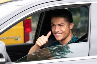 TURIN, ITALY - MAY 19: Juventus' Portuguese forward Cristiano Ronaldo exit in his car to resume training after a quarantine on May 19, 2020 at the club's Continassa training ground in Turin, as the country's lockdown is easing after over two months, aimed at curbing the spread of the COVID-19 infection, caused by the novel coronavirus. during the   Cristiano Ronaldo arrival at the Turin on May 19, 2020 in Turin Italy (Photo by Mattia Ozbot/Soccrates/Getty Images)