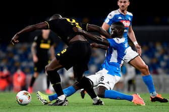 Napoli's Senegalese defender Kalidou Koulibaly (R) tackles Inter Milan's Belgian forward Romelu Lukaku during the Italian Cup (Coppa Italia) semi-final second leg football match Napoli vs Inter Milan on June 13, 2020 at the San Paolo stadium in Naples, played behind closed doors as the country gradually eases its lockdown aimed at curbing the spread of the COVID-19 infection, caused by the novel coronavirus. (Photo by Filippo MONTEFORTE / AFP) (Photo by FILIPPO MONTEFORTE/AFP via Getty Images)